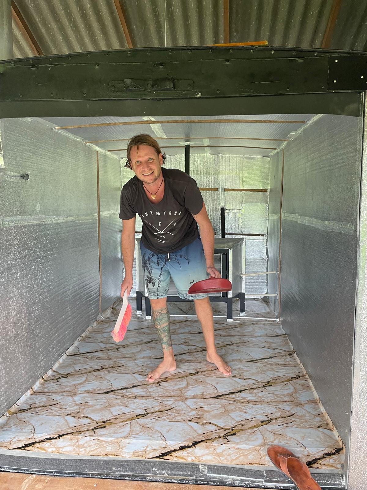 Daniel cleaning the drying room